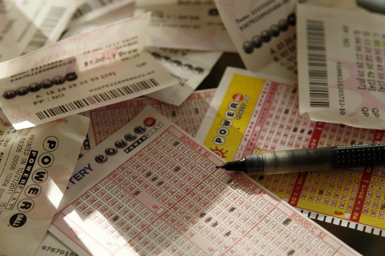 Powerball play slips and former losing lottery tickets are shown in this Reuters photo illustration November 26, 2012.