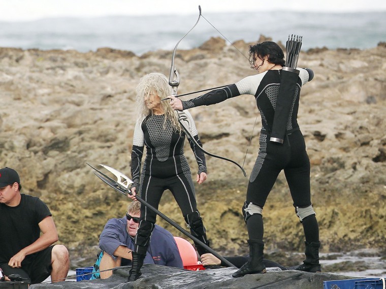 New characters will include Mags and Finnick. The photo above is believed to show Lawrence with Lynn Cohen, who plays Mags, but may also be a stunt double.