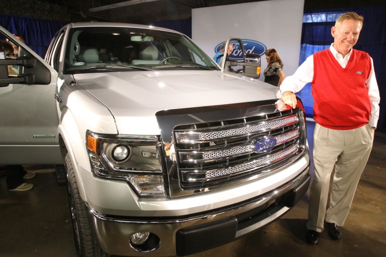 Alan Mulally, President and CEO of the Ford Motor Company, stands next to the new 2013 Ford F-150 pickup truck after it was unveiled Monday June 4, 20...