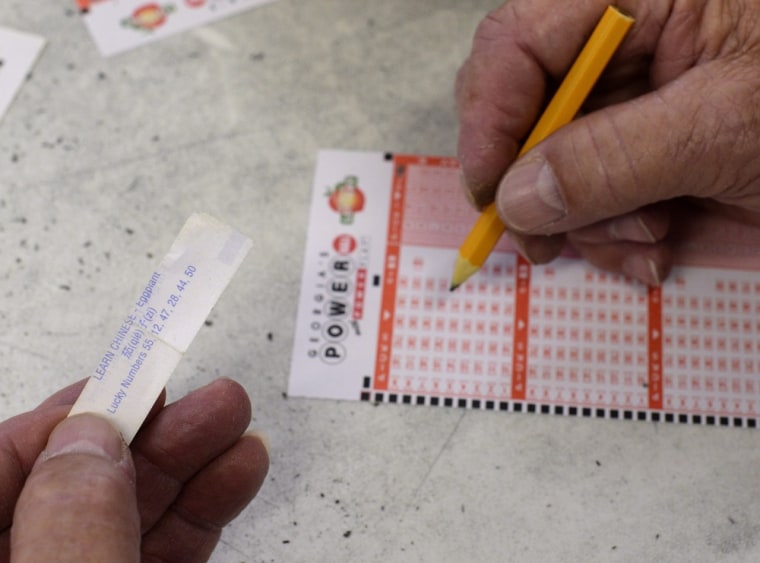 Jimmie Callahan of Pell City, Alabama, uses the lucky numbers from a Chinese restaurant fortune cookie to play the Powerball multi-state lottery at a retailer near the Alabama state line in Tallapoosa, Georgia.
