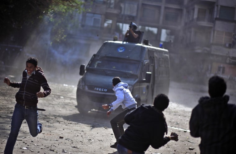 Egyptian protesters clash with security forces near Tahrir square, in Cairo, Egypt, on Nov. 28. Egyptian state television says the country's highest appeal court has decided to suspend its work nationwide to protest the president's decrees giving himself nearly absolute powers.