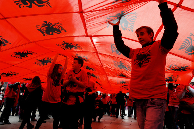 Kosovo Albanian youth march under Albanian flags during celebrations for the 100th anniversary of Albania's independence in Pristina, Kosovo, Nov. 28, 2012.