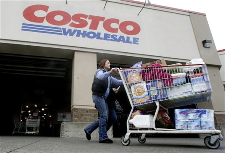 A shopper leaves a Costco store in Portland, Ore., in this Dec. 7, 2011, file photo.