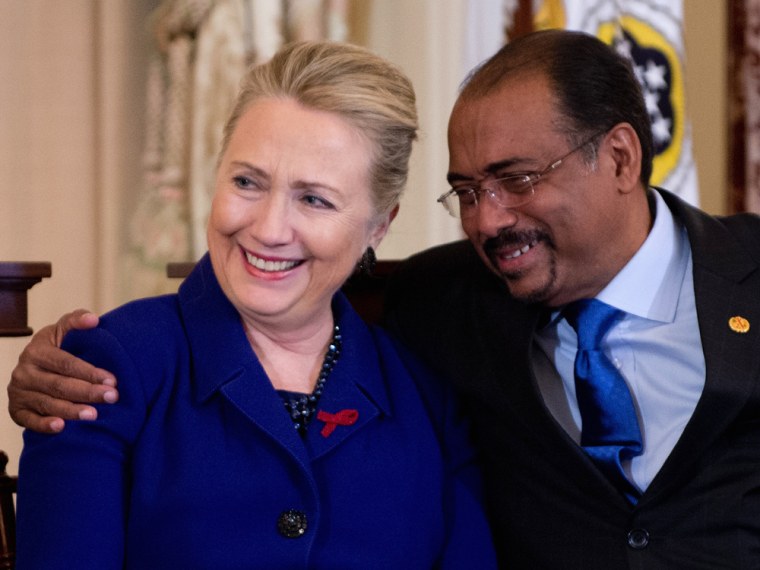 Secretary of State Hillary Clinton, left, is hugged by United Nations AIDS Executive Director Michel Sidibe during an event in recognition of World AIDS Day at the State Department in Washington, D.C., on Nov. 29.