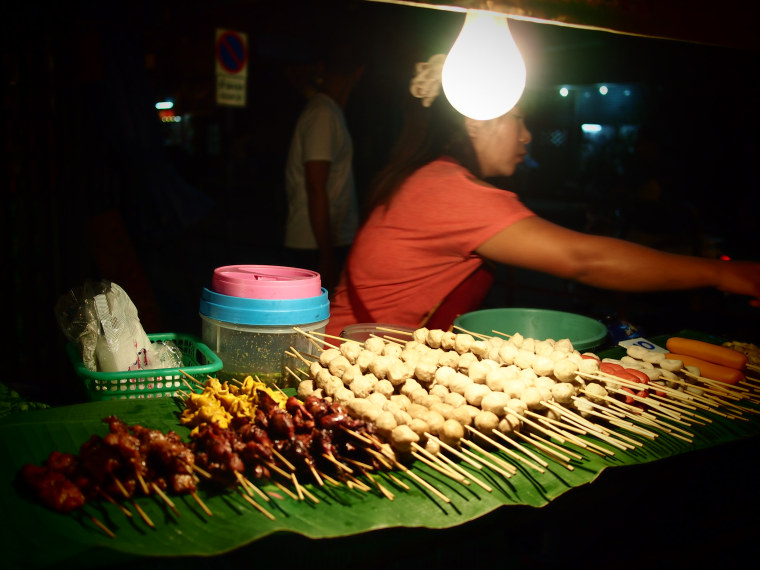 A street vendor selling sausage in Chiang Mai, Thailand .