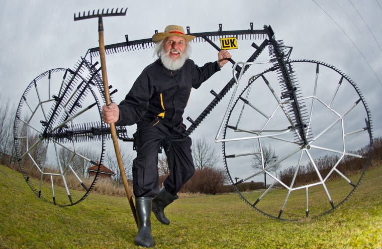 Dieter Senft presents his so-called '111-twelve-teeth-rake-bicycle' in Storkow, Germany, on March 12, 2012. The bicycle consists of 111 garden rakes and is fully functional but cannot be used for raking.