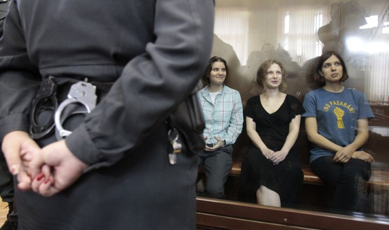Nadezhda Tolokonnikova, Maria Alyokhina and Yekaterina Samutsevich of punk band Pussy Riot sit in a glass-walled cage during a court hearing in Moscow on August 17.