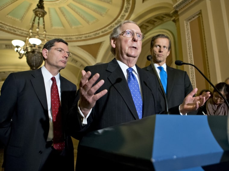 Senate Minority Leader Mitch McConnell of Ky., center, accompanied by Sen. John Barrasso, R-Wyo., left, and Sen. John Thune, R-S.D., gestures while speaking to reporters on Capitol Hill in Washington, Tuesday, Nov, 27, 2012.