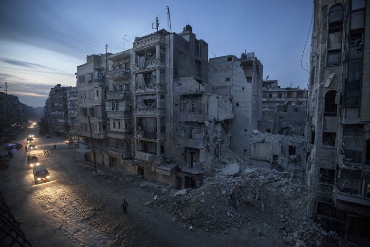 Night falls on a Syrian rebel-controlled area as destroyed buildings, including Dar Al-Shifa hospital, are seen on Sa'ar street after airstrikes targeted the area last week, killing dozens in Aleppo, Syria.