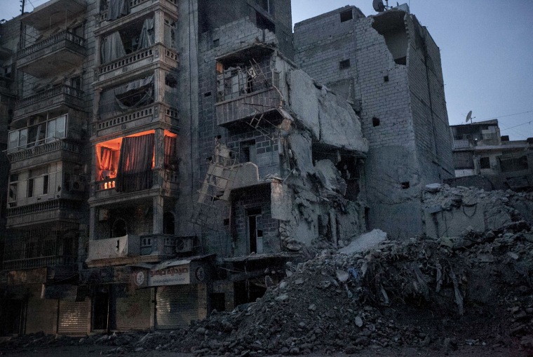 On Sa'ar street in Aleppo, an apartment is illuminated by fire used to keep warm.