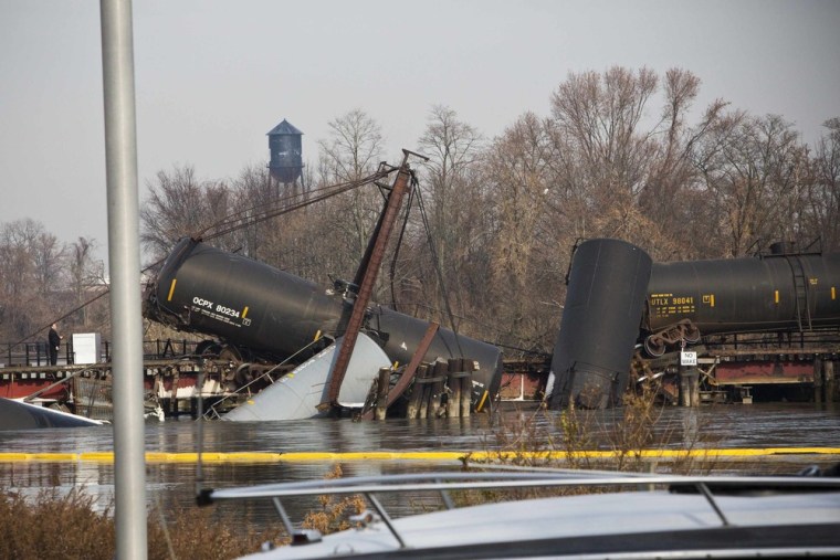 Derailed freight train cars leak vinyl chloride, a colorless, organic gas with a sweet odor sit semi-submerged in the waters of Mantua Creek after a train crash, in Paulsboro, N.J., Nov. 30.