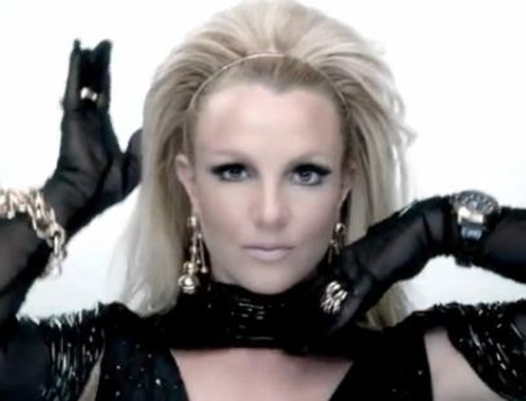 Britney Spears moves her hands around her head.