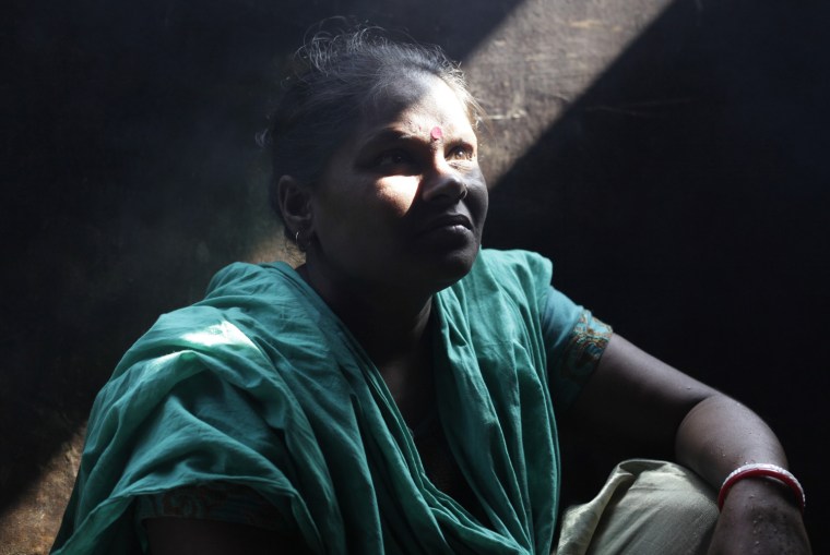 Sabita Rani, 35, sits in her kitchen in Savar, Bangladesh, Nov. 30, 2012. Rani, an operator at the Tazreen Fashions garment factory, escaped the fire that killed more than 100 workers on Nov. 24. According to Rani, the factory manager did not let workers escape after hearing the fire bell, but Rani jumped from the third floor to save herself after her colleagues managed to break a window.