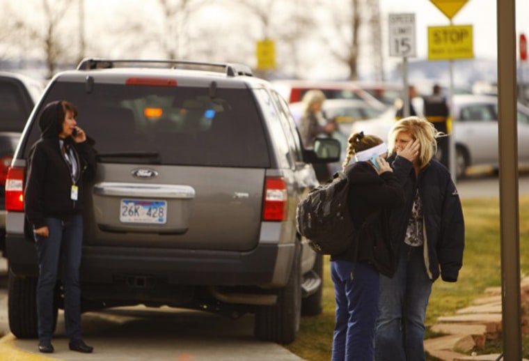 Students and faculty mingle outside the police line on the Casper College campus Friday, Nov. 30, as police investigate a homicide.