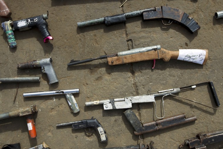 Weapons are lined up during a public destruction of confiscated weapons in Lara, Venezuela, Nov. 30.