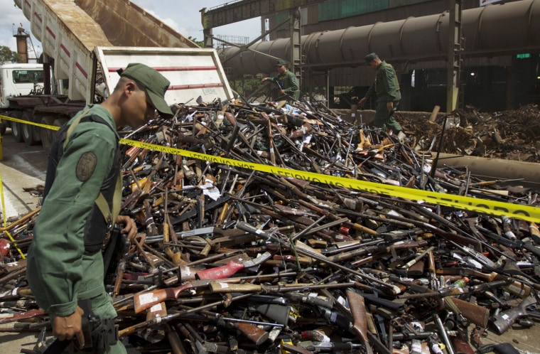 Soldiers stand guard during a public destruction of confiscated weapons in Lara, Venezuela, Nov. 30, 2012.