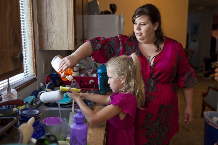 Michelle Guerrero, seen here with daughter Elizabeth Veihl, 7, is undecided about who to vote for.