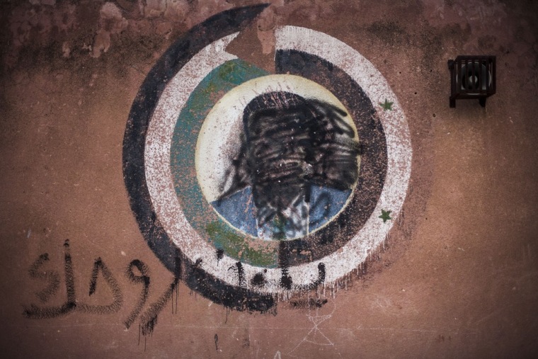 A defaced portrait of President Bashar al Assad is seen in a school used as an emergency refugee camp in Souran village, near the Turkish border with Syria, on Oct. 1, 2012.