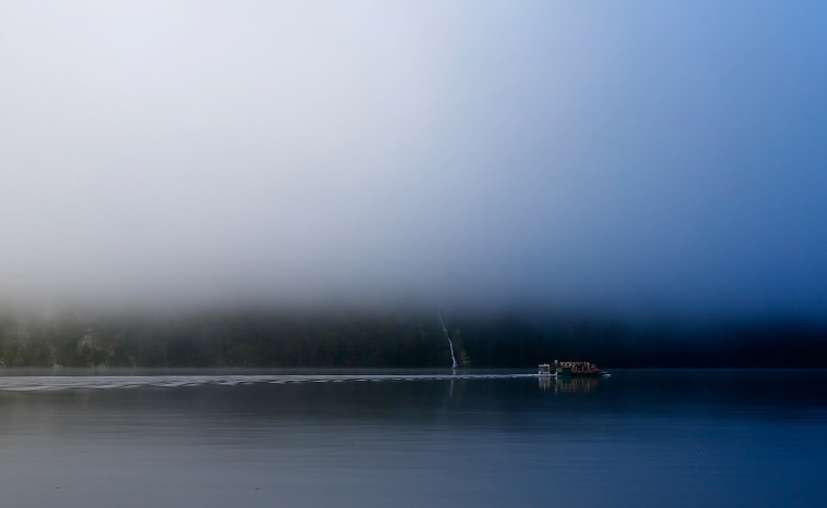 Bavarian farmers transport their cows on a boat over the picturesque Lake Koenigssee early morning on Oct. 3.