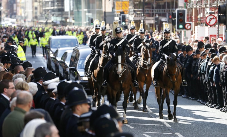 Crowds line the streets to watch the coffin of Nicola Hughes as it is driven to Manchester Cathedral for her funeral service on Oct. 3