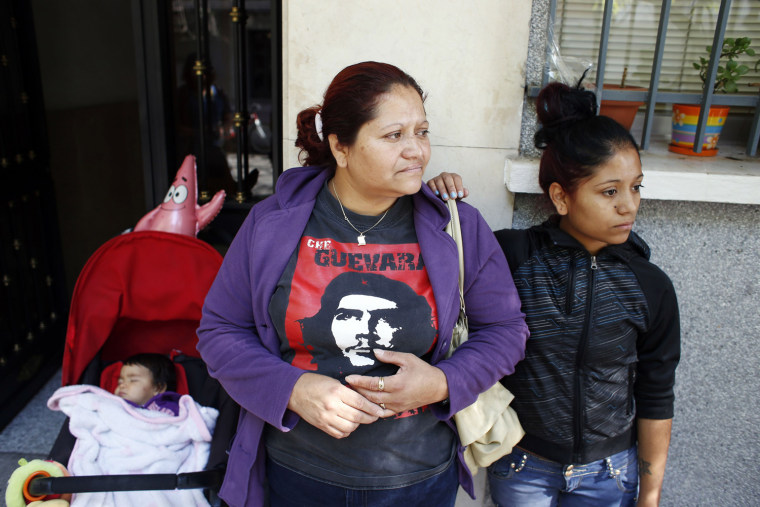 Marisol Solorza, an immigrant from Ecuador (center), her daughter Gema and her granddaughter stand outside their apartment after learning that their family's eviction has been suspended, in Madrid on Oct. 3.