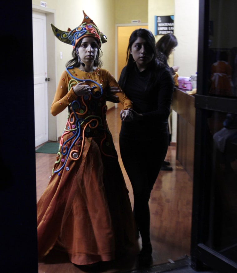 Actress Marisol Nunez, left, who is blind, is led to stage ahead of her performance in