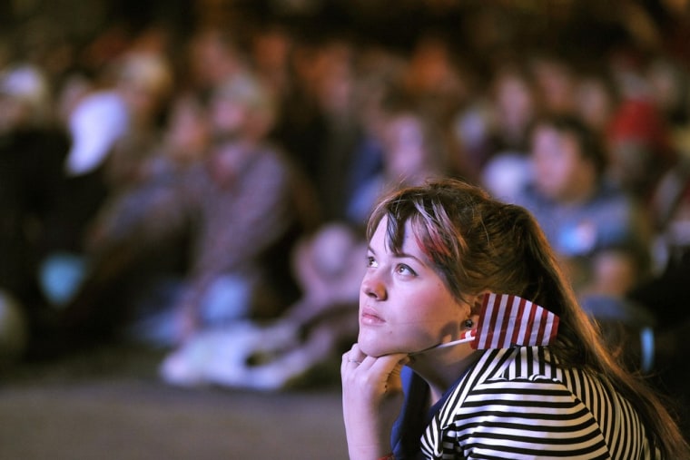 Caitlin Alexander, 20, a supporter of President Barack Obama. watches the debate on a screen outside at the University of Denver.