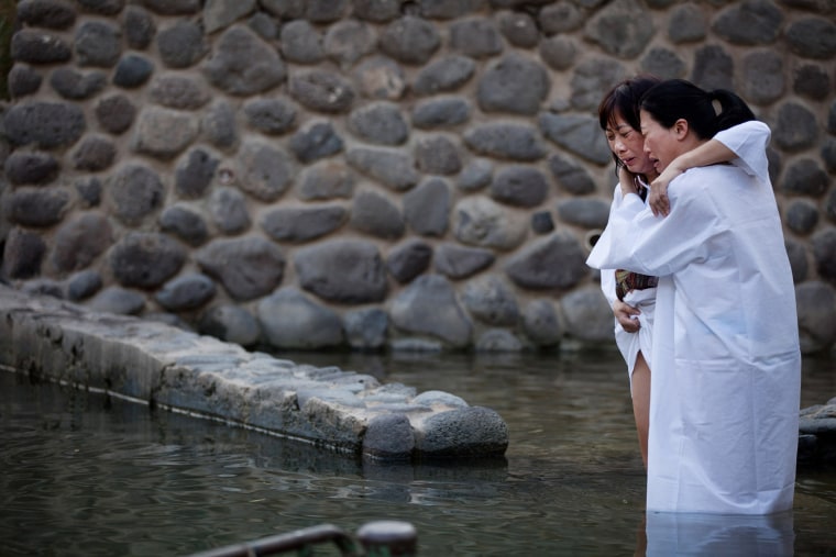 Christian pilgrims take part in a baptism in the waters of the Jordan River at Yardenit in northern Israel, Oct. 3.