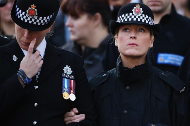 Police officers listen to the funeral service for Greater Manchester Police Officer Fiona Bone outside Manchester Cathedral on Oct. 4, in Manchester, England.
