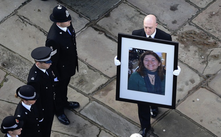 A portrait of Greater Manchester Police constable Fiona Bone is carried into Manchester Cathedral for her funeral service.