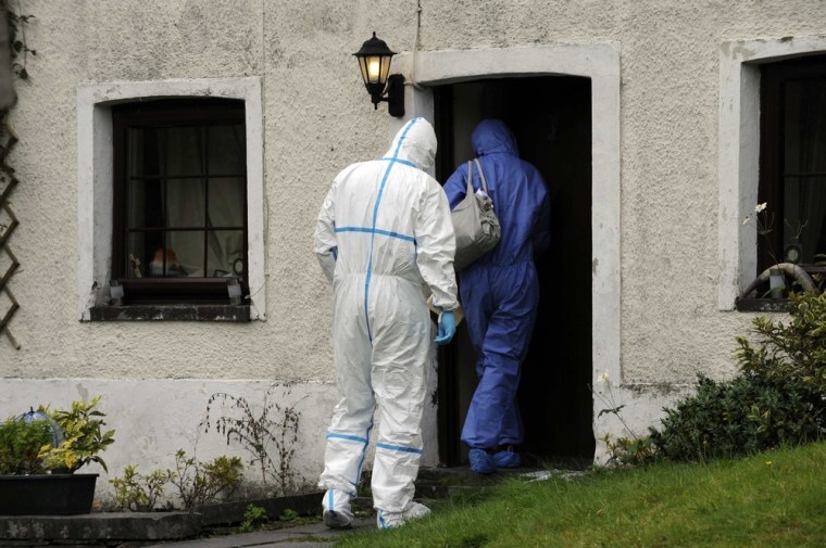 Police forensic officers enter Mark Bridger's house in Esgairgeiliog, Mid Wales on Oct. 4. Police continued to question Bridger about the disappearance of five-year-old April Jones, who went missing from her home town of Machynlleth, on Monday.