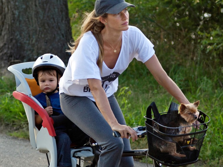 Gisele Bundchen and son Benjamin Brady on a bike with Gisele's dog, Vida.