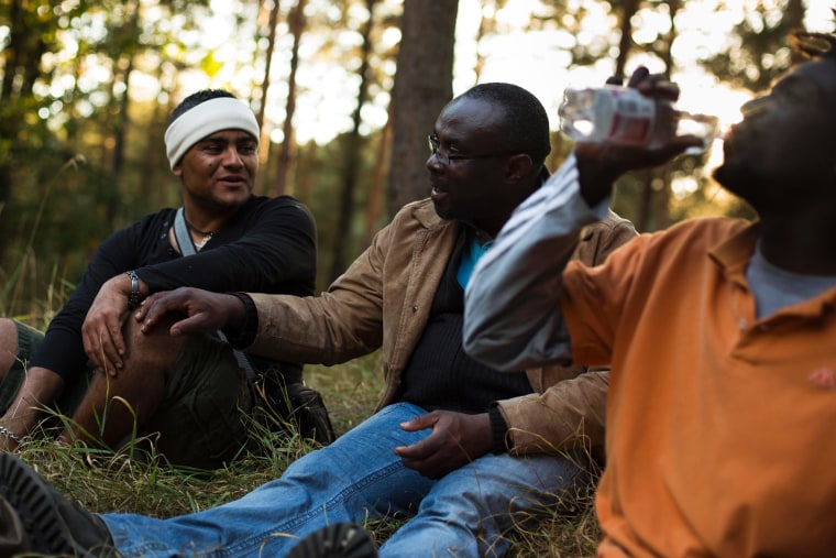 Refugees chat as they take a break during a protest march near the village of Ferch on October 3, 2012.