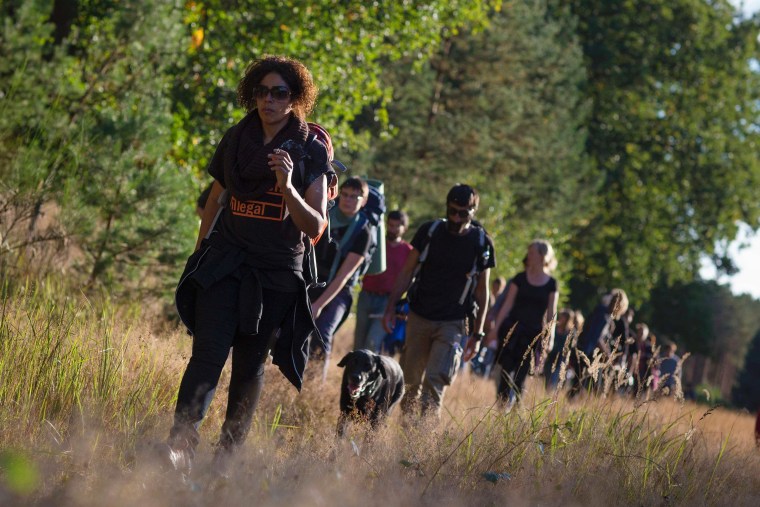 Refugees walk through a forest clearing during a protest march through Germany near the village of Ferch, near Potsdam, October 3, 2012.