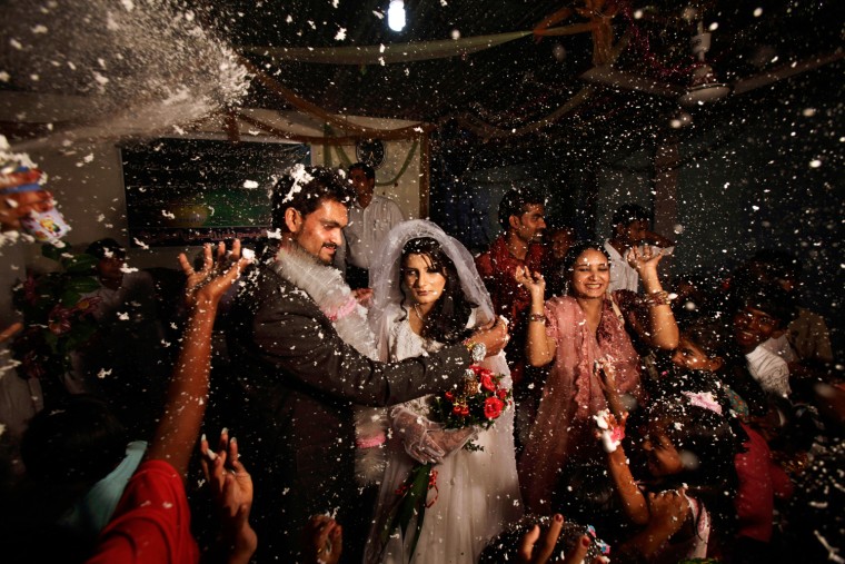 Pakistani groom, Phaloos Sohtra, 22, unveils his bride Shabana Gill, 20, during their wedding in a church in a Christian neighborhood in Islamabad, Pakistan, on Oct. 5.