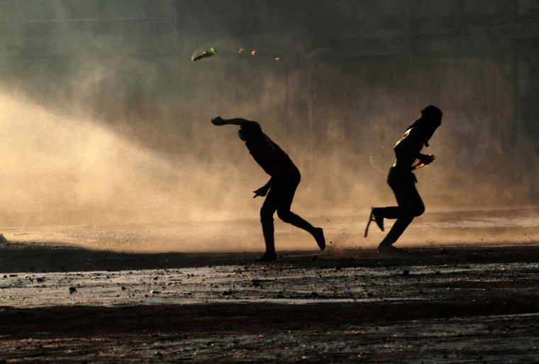 Bahraini anti-government protesters throw petrol bombs at a police water cannon truck during clashes with riot police in Sanabis, Bahrain, Oct. 5.