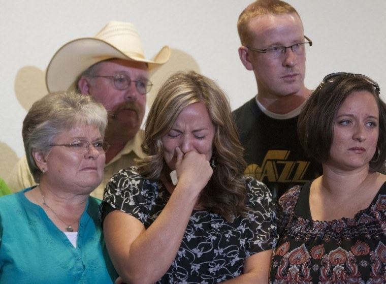 Christy Ivie, center, wife of Nicholas Ivie, holds back tears as she is surrounded by her father, Tracy Morris, and mother, DeAnn Morris, left, and her sister, Jan Cloward, and brother, Travis Morris, right, during news conference on Tuesday.