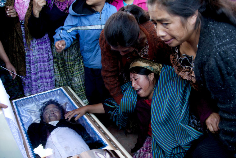 Relatives mourn in front of the casket holding Francisco Ordonez during a mass funeral service in Totonicapan, Guatemala, Oct. 5, 2012. Ordonez is one of at least six people slain when gunfire erupted Thursday during a protest over electrical power prices and educational reform in a poor rural area west of the capital.