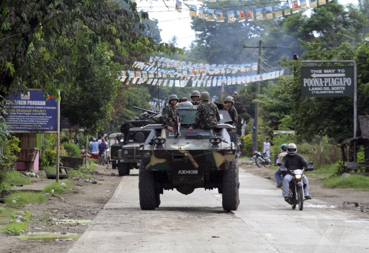 Philippine soldiers patrol the town of Kauswagan in Lanao del Norte, southern Philippines, in August, 2008. The Philippine government and Muslim rebels have agreed a peace deal to end a 40-year conflict that has killed more than 120,000 people, President Benigno Aquino said on Sunday.