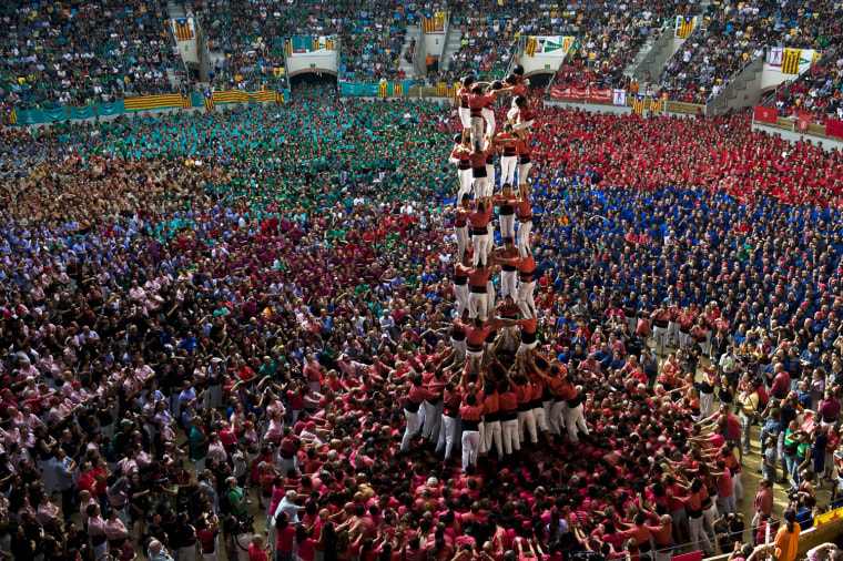 Members of the Colla 'Vella de Valls' climb up as they construct a human tower during the 24th Tarragona Castells Comptetion on Oct. 7, in Tarragona, Spain.