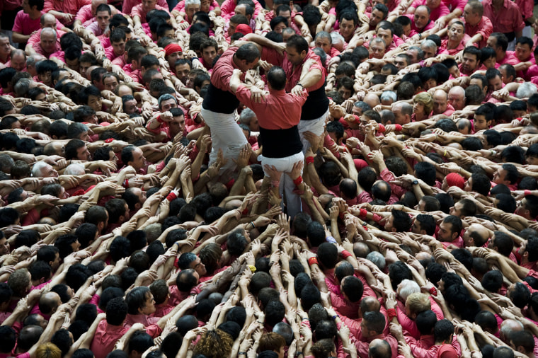 Members of the Colla 'Vella de Valls' start a construction of a human tower during the 24th Tarragona Castells Comptetion on Oct. 7, in Tarragona, Spain.
