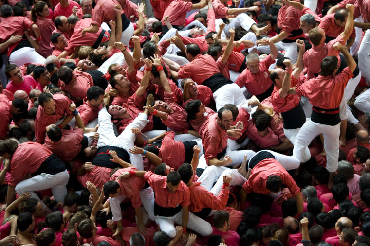 Members of the Colla 'Vella de Valls' celebrate after building a human tower during the 24th Tarragona Castells Comptetion on Oct. 7, in Tarragona, Spain.