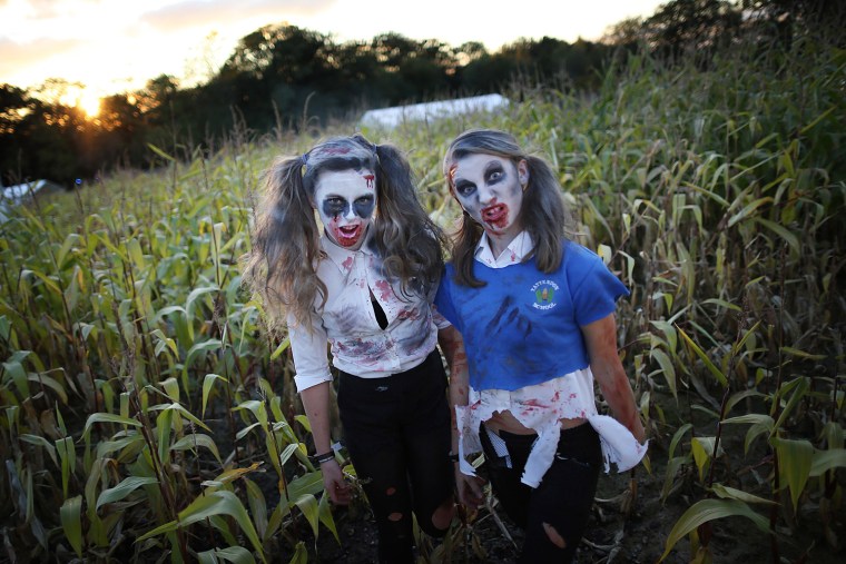 Visitors to the Shocktober Fest dressed as zombies pose at Tulleys Farm on Oct. 6, in Turners Hill, England. People dressed as zombies from around the United Kingdom have converged on Tulleys Farm in an attempt to set a new Guinness World Record for the most zombies together in one place.