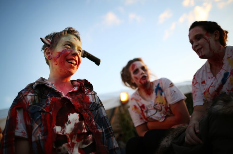 Visitors to the Shocktober Fest dressed as zombies enjoy the occasion at Tulleys Farm on Oct. 6, in Turners Hill, England.