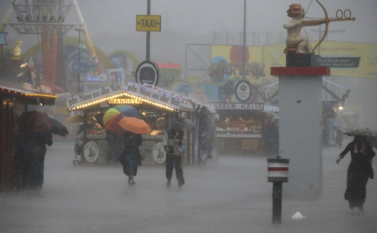 Oktoberfest visitors take cover during heavy rain at the last day of the world biggest beer festival in Munich on Oct. 7.