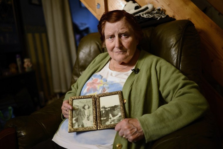 Jennie Iveson, aged 69, poses with family photographs inside her terraced home in Barrow-in-Furness. Jennie is Mitt Romney's fourth cousin.