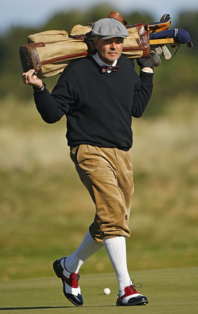 A competitor taking part in the World Hickory Open golf championship carries his bag during the first round on Oct. 8.
