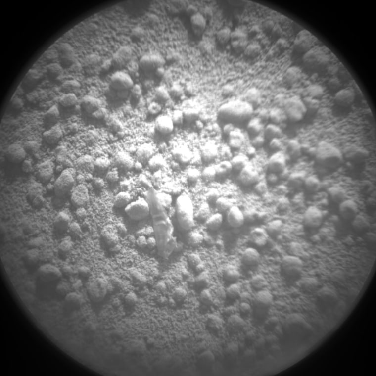 A picture from the ChemCam imager on NASA's Curiosity rover appears to show a shred of plastic at the center. Is that what the tiny mystery object will turn out to be? Stay tuned.