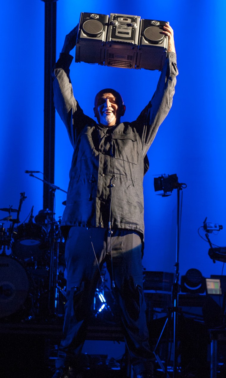 Peter Gabriel holds up the boombox given to him by John Cusack.