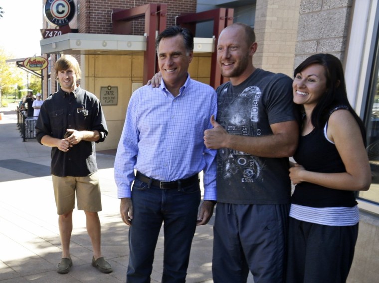 Republican presidential candidate Mitt Romney takes a picture for well-wishers after an unscheduled stop at a Chipotle restaurant in Denver, Tuesday, Oct. 2, 2012.